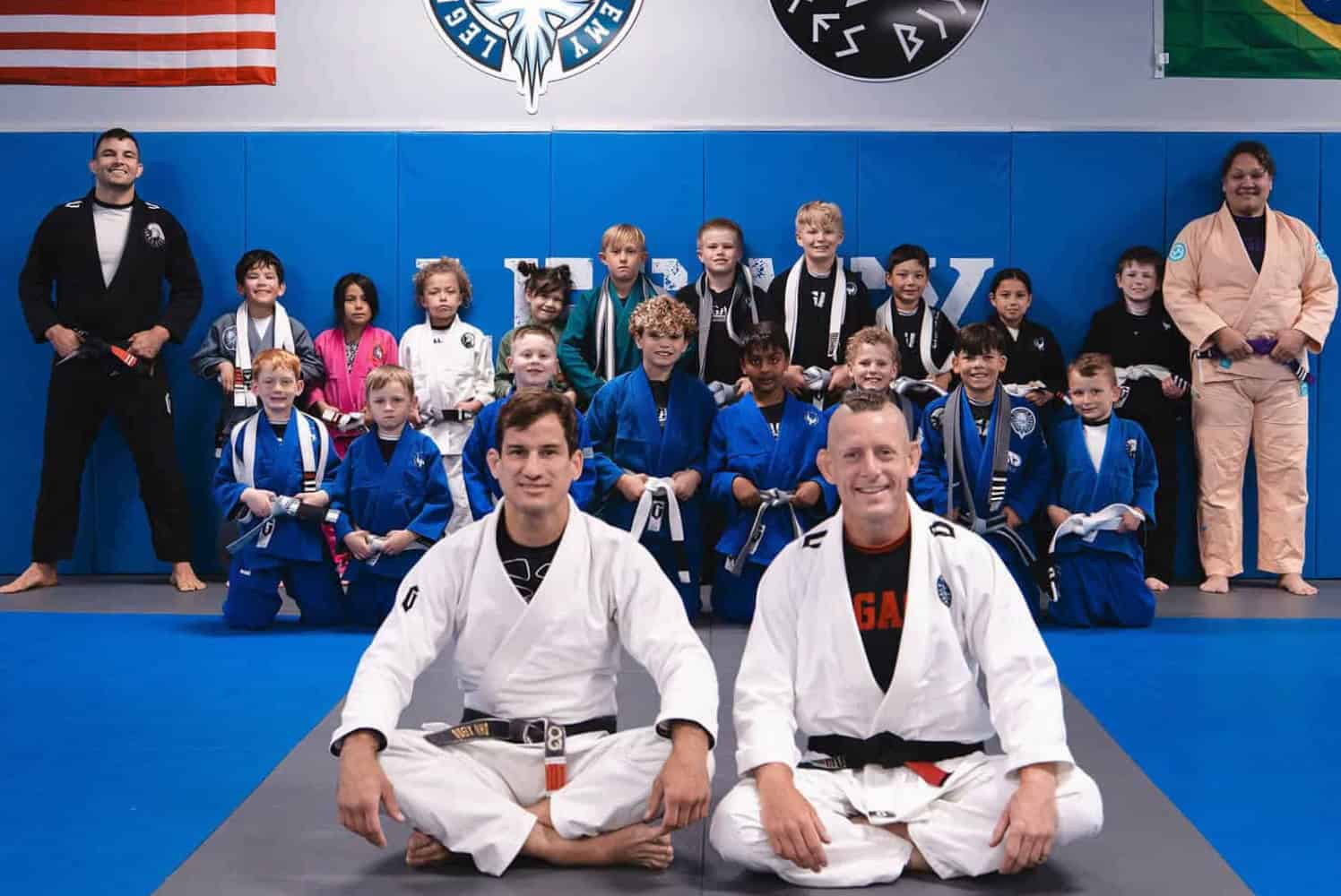 Group of children and instructors practicing Brazilian Jiu-Jitsu at Legacy Jiu-Jitsu Academy.